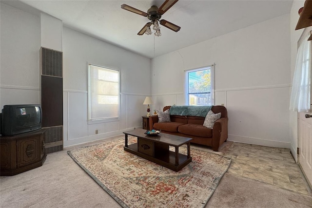 living room featuring ceiling fan, a healthy amount of sunlight, and light carpet