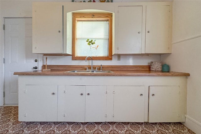 kitchen with white cabinetry and sink