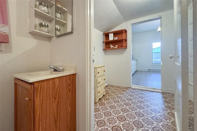 bathroom featuring vanity and lofted ceiling