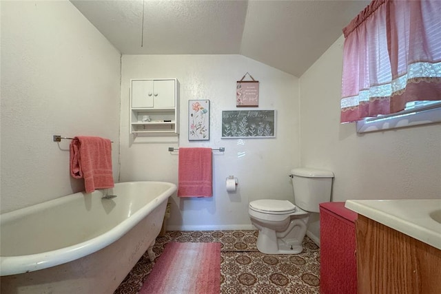 bathroom with vanity, tile patterned flooring, lofted ceiling, toilet, and a bathing tub