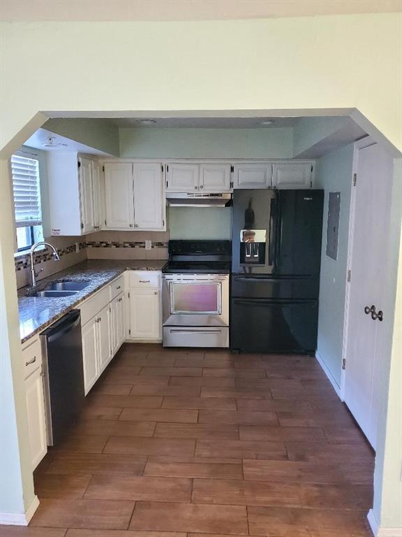 kitchen featuring dark wood-type flooring, sink, white cabinets, and black appliances