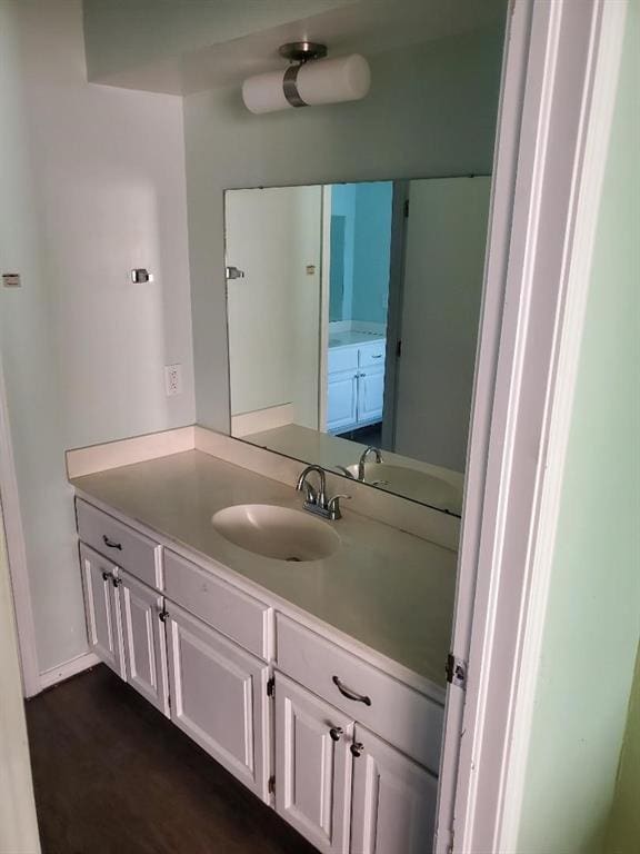 bathroom featuring vanity and wood-type flooring