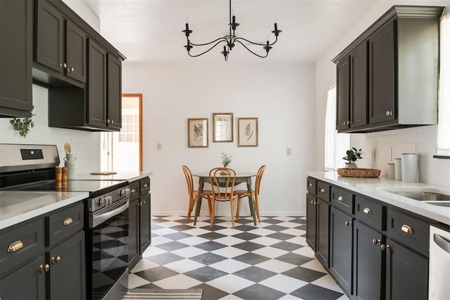 kitchen featuring decorative backsplash, sink, an inviting chandelier, and appliances with stainless steel finishes