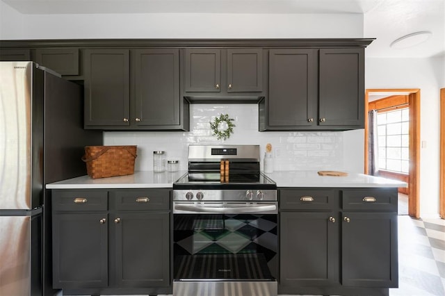 kitchen with appliances with stainless steel finishes and tasteful backsplash