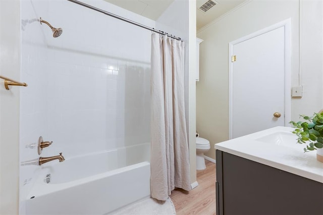 full bathroom featuring shower / bath combination with curtain, vanity, crown molding, wood-type flooring, and toilet