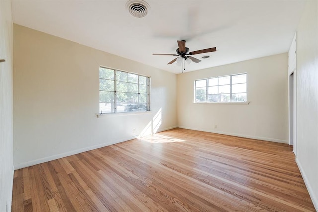 empty room featuring ceiling fan and light wood-type flooring