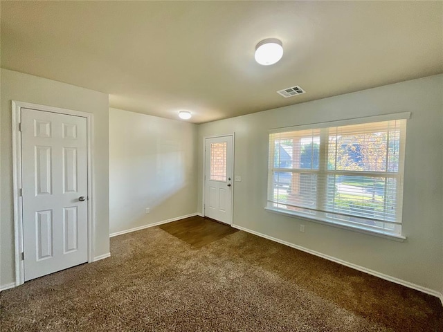 interior space featuring dark carpet