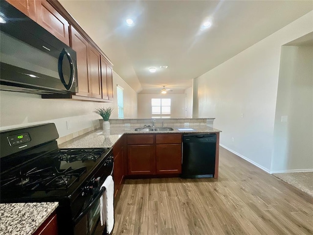 kitchen featuring ceiling fan, sink, black appliances, and light wood-type flooring