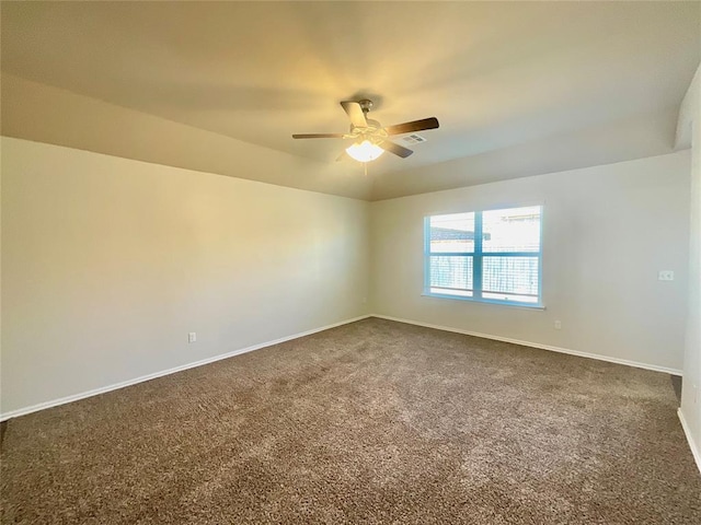 unfurnished room featuring dark carpet and ceiling fan