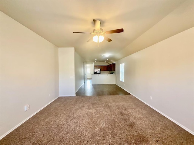 carpeted spare room featuring ceiling fan and lofted ceiling