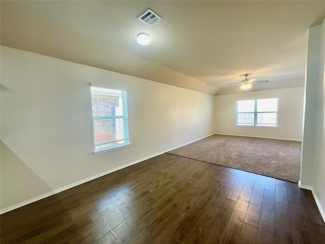 empty room with dark hardwood / wood-style flooring and ceiling fan