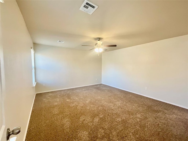 carpeted spare room with ceiling fan