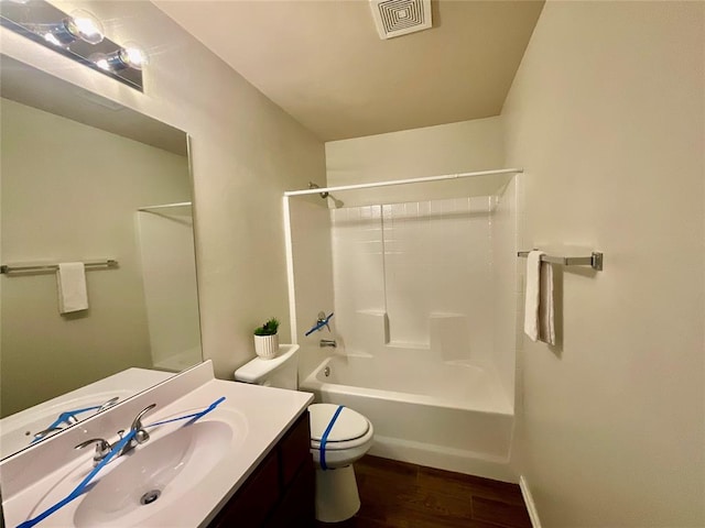 full bathroom featuring vanity, toilet, wood-type flooring, and shower / washtub combination