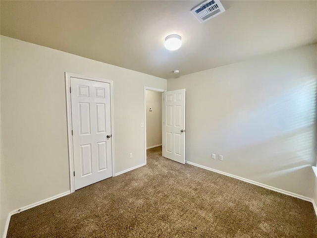 unfurnished bedroom with a closet and carpet