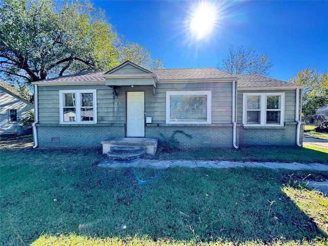 ranch-style home featuring a front yard