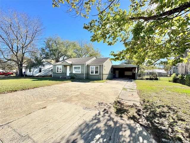 ranch-style house with a front yard and a carport