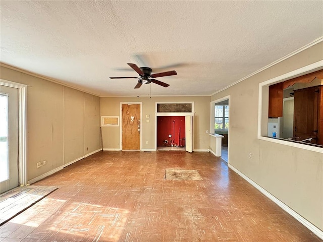 spare room featuring ceiling fan, crown molding, and a textured ceiling