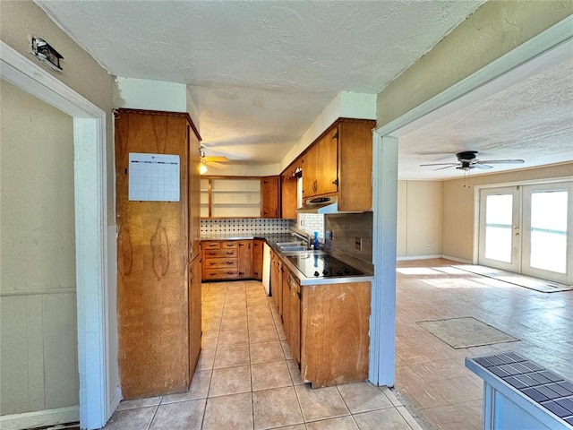 kitchen with french doors, backsplash, ceiling fan, sink, and tile countertops