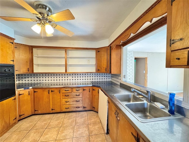 kitchen featuring backsplash, sink, oven, and white dishwasher