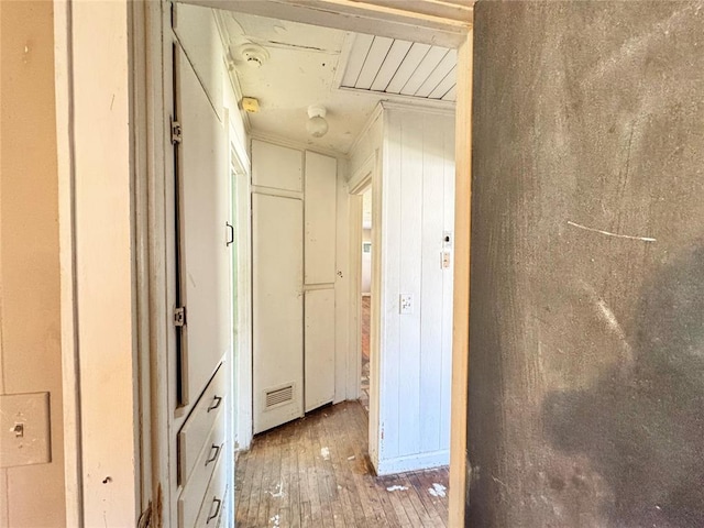 hallway with hardwood / wood-style floors and crown molding