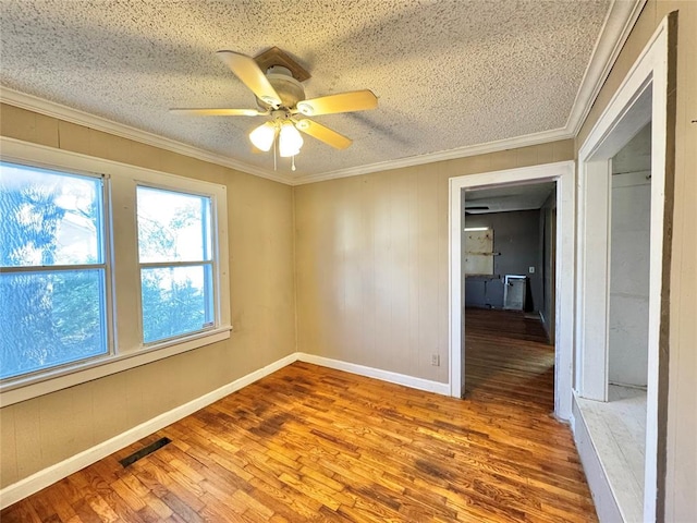 unfurnished room with hardwood / wood-style floors, a textured ceiling, ceiling fan, and crown molding