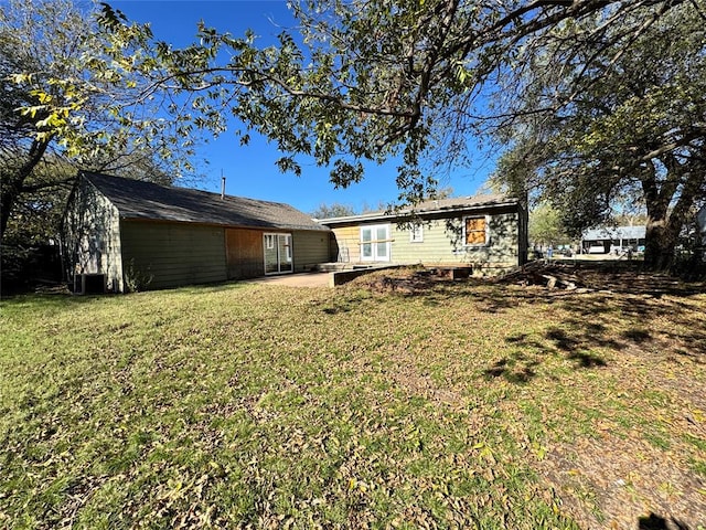 rear view of house featuring a patio area and a lawn