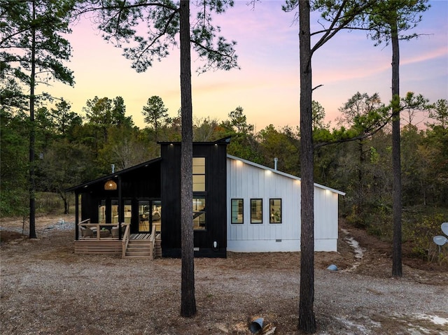 property exterior at dusk featuring a porch