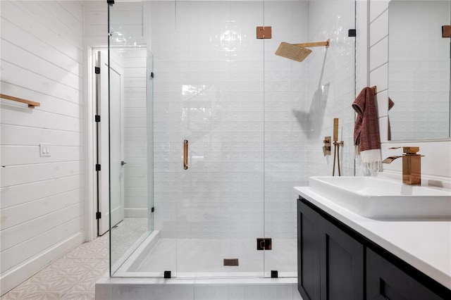 bathroom with vanity and a shower with shower door