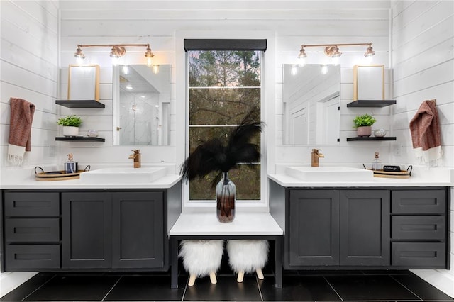 bathroom featuring tile patterned flooring, a healthy amount of sunlight, and wood walls