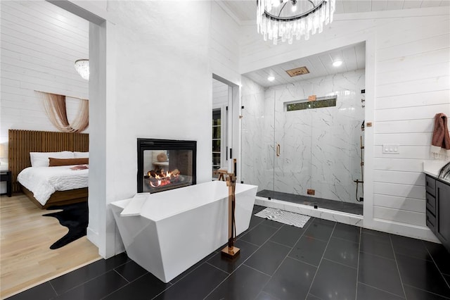 bathroom featuring vanity, hardwood / wood-style flooring, high vaulted ceiling, independent shower and bath, and a multi sided fireplace