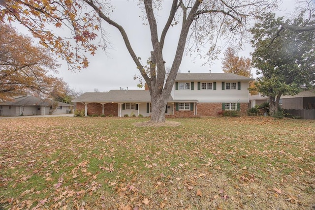 rear view of house featuring a lawn