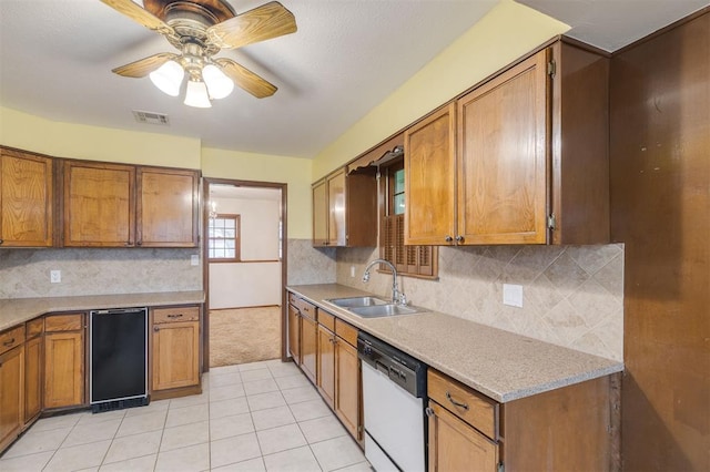 kitchen with ceiling fan, sink, backsplash, white dishwasher, and light tile patterned floors