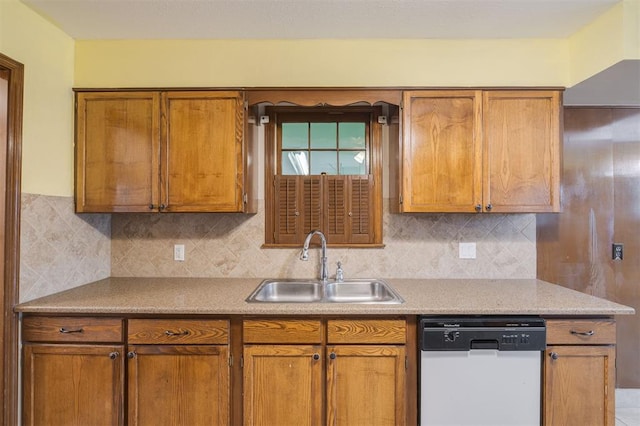 kitchen with backsplash, dishwasher, and sink