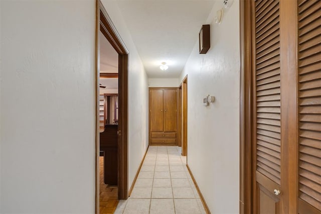 corridor featuring light tile patterned flooring