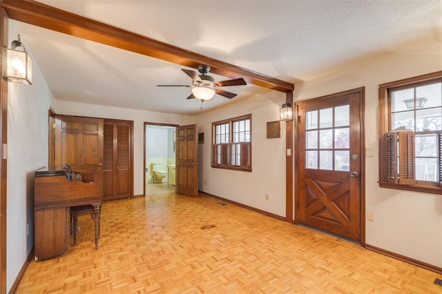 doorway to outside featuring ceiling fan, a wealth of natural light, and light parquet flooring