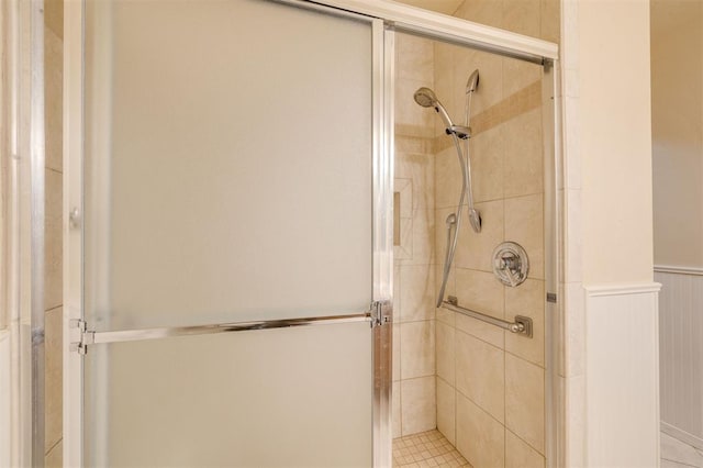 bathroom featuring a shower with shower door