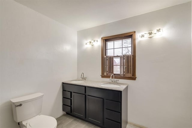 bathroom with hardwood / wood-style flooring, vanity, and toilet