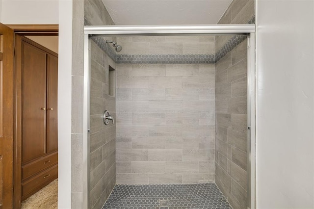 bathroom featuring a shower with door