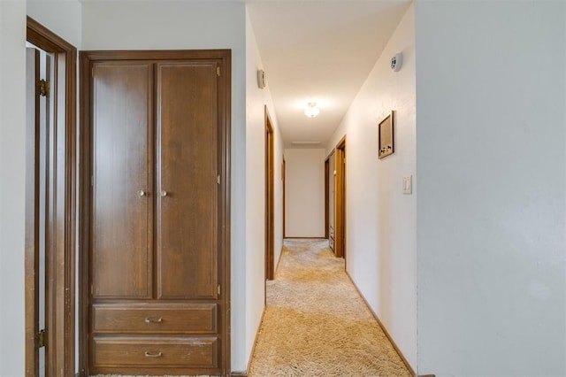 hallway with light colored carpet