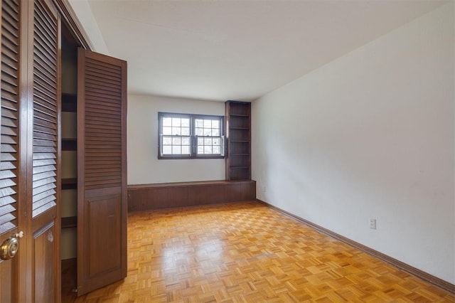 unfurnished bedroom with light parquet flooring