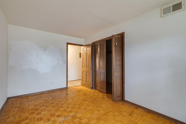 unfurnished bedroom featuring light parquet flooring