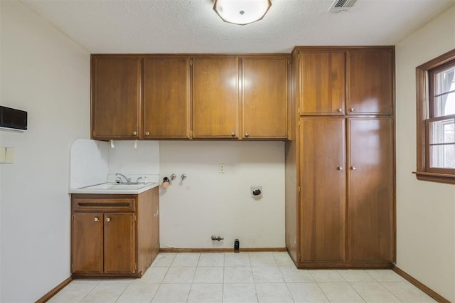 clothes washing area with cabinets, hookup for a washing machine, hookup for an electric dryer, sink, and hookup for a gas dryer