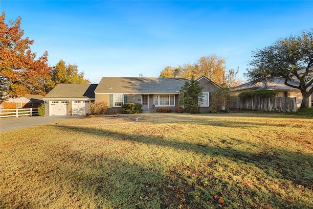 ranch-style house with a garage and a front lawn