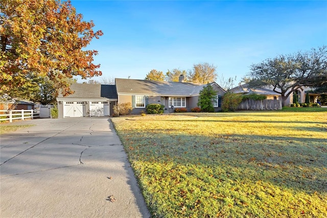 ranch-style home with a front yard and a garage