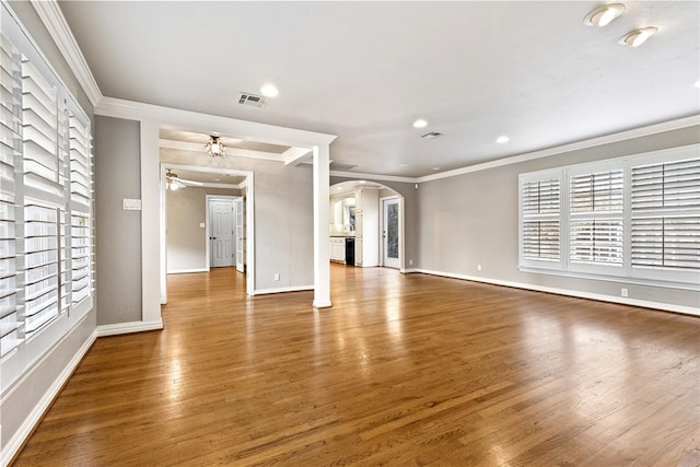 unfurnished living room with hardwood / wood-style flooring, ceiling fan, and ornamental molding