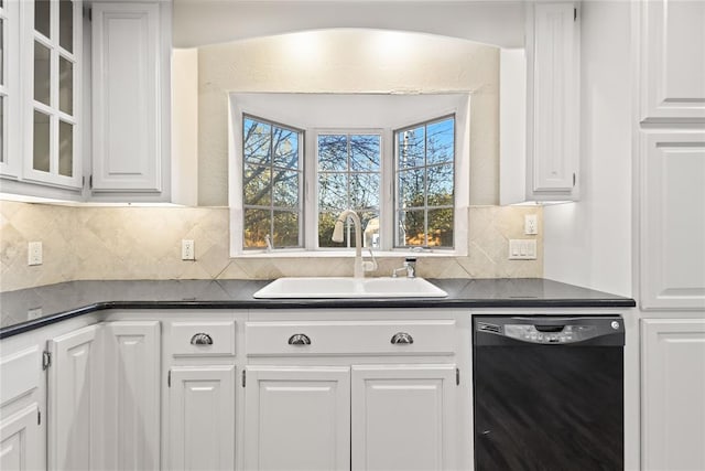 kitchen featuring backsplash, dishwasher, white cabinetry, and sink