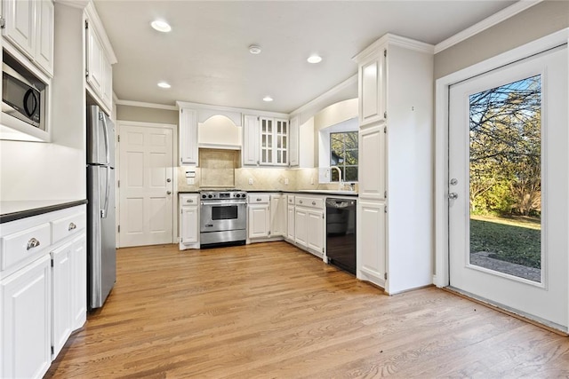 kitchen featuring white cabinets, a healthy amount of sunlight, and appliances with stainless steel finishes