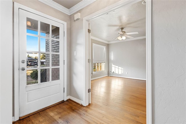 entryway featuring hardwood / wood-style flooring, ceiling fan, and crown molding