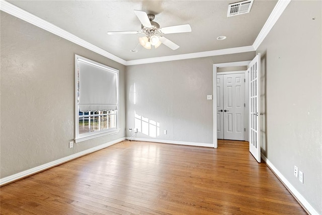 spare room featuring hardwood / wood-style floors, ceiling fan, and ornamental molding