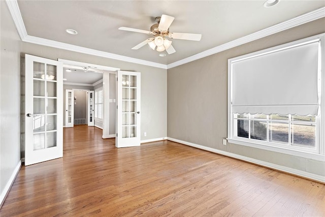 unfurnished room with french doors, ceiling fan, crown molding, and wood-type flooring